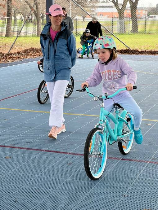 Ceci Kinnane, 7, and her mother, Clare Kinnane, at Pedal Power ACT's kids learn to ride class in Lyneham in July 2023. Picture supplied