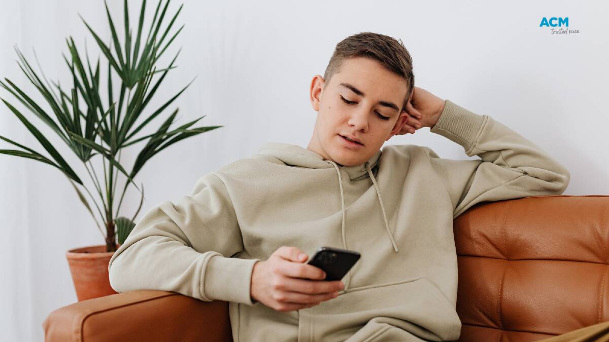 Stock photo of a teen boy texting. Picture Canva