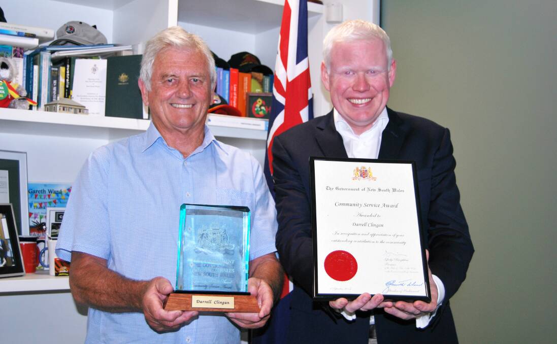 Kiama MP Gareth Ward presents the Premier’s Community Service Award to Gerringong's Darrell Clingan.