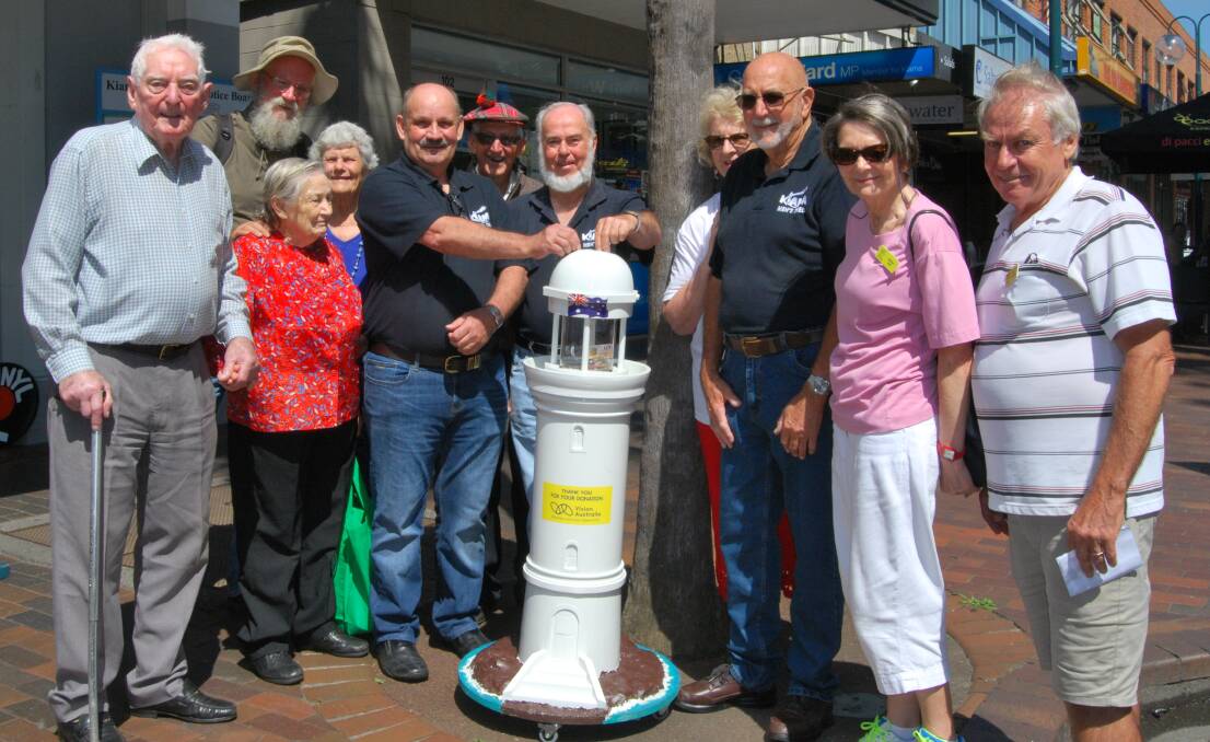 Representatives from Kiama Friends of Vision Australia and Kiama Mens Shed unveil the new-look collection box on Terralong Street on Friday.