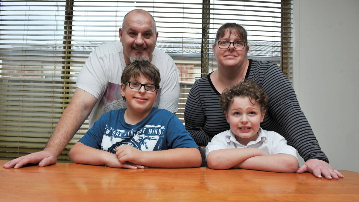 Angela and Allister Dobbin with their two sons, Harryson, 12, and Flynn, six. Both boys have autism, but require different kinds of support. Picture: Lachlan Bence. 