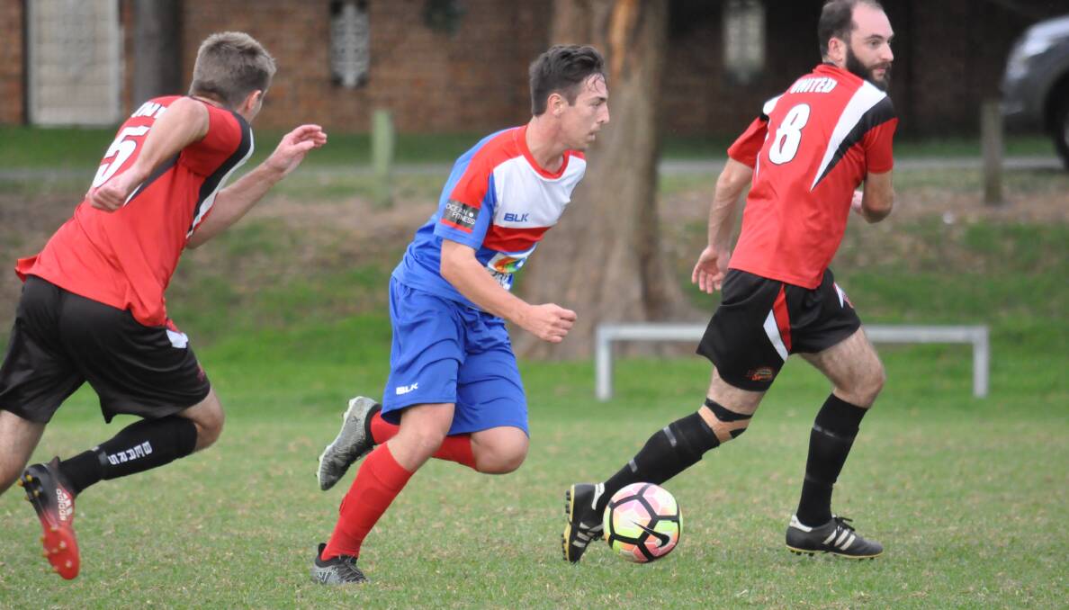 ATTACK: Gerringong Breakers' Jake Packham pushes the ball forward during his side's 10-1 demolition against Shoalhaven United on Saturday.