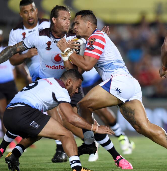 Fiji's Ashton Sims makes a tackle on United States' Bureta Faraimo. Photo: NRL PHOTOS