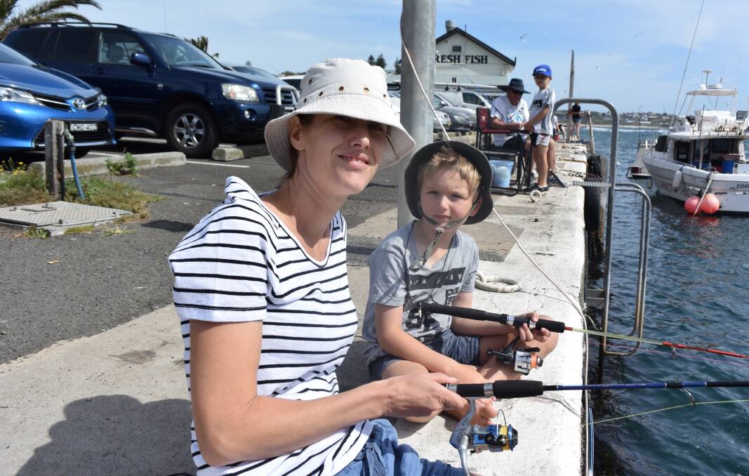 Sarah and Quinn Turcata sitting alongside Kiama Harbour waiting to catch a fish during the charity competition. 