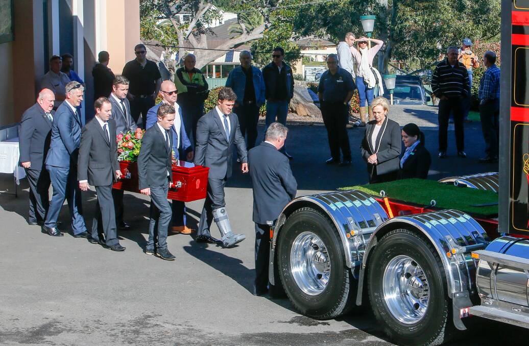 Pallbearers carry the coffin of Gary Robertson to the truck for what would be his last ride. The truckie was remembered as a man with a great sense of humour and who kept his promises.