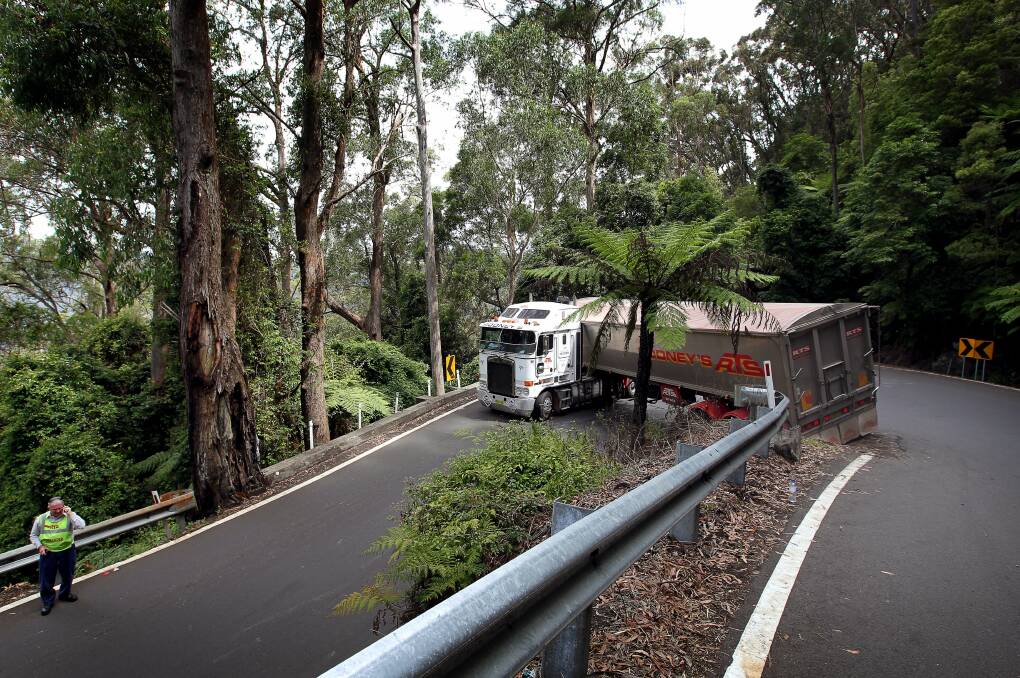 A truck trapped on a hairpin bend along Macquarie Pass in 2013. Roads and Maritime Services are looking at ways of improving the reliability of the road. Picture: Sylvia Liber