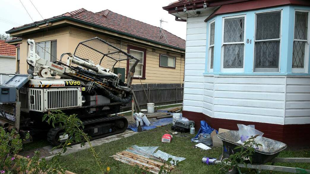 UNDER THE MICROSCOPE: Crews drilling at a property on Turton Road in Waratah on Friday. The homes have been contaminated by the old gasworks. Picture: Marina Neil