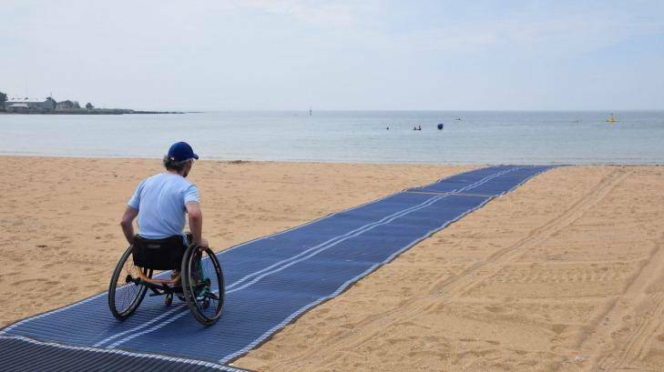BEACH DAY: Brook Quinn tests the wheelchair-accessible matting. Photo: Supplied