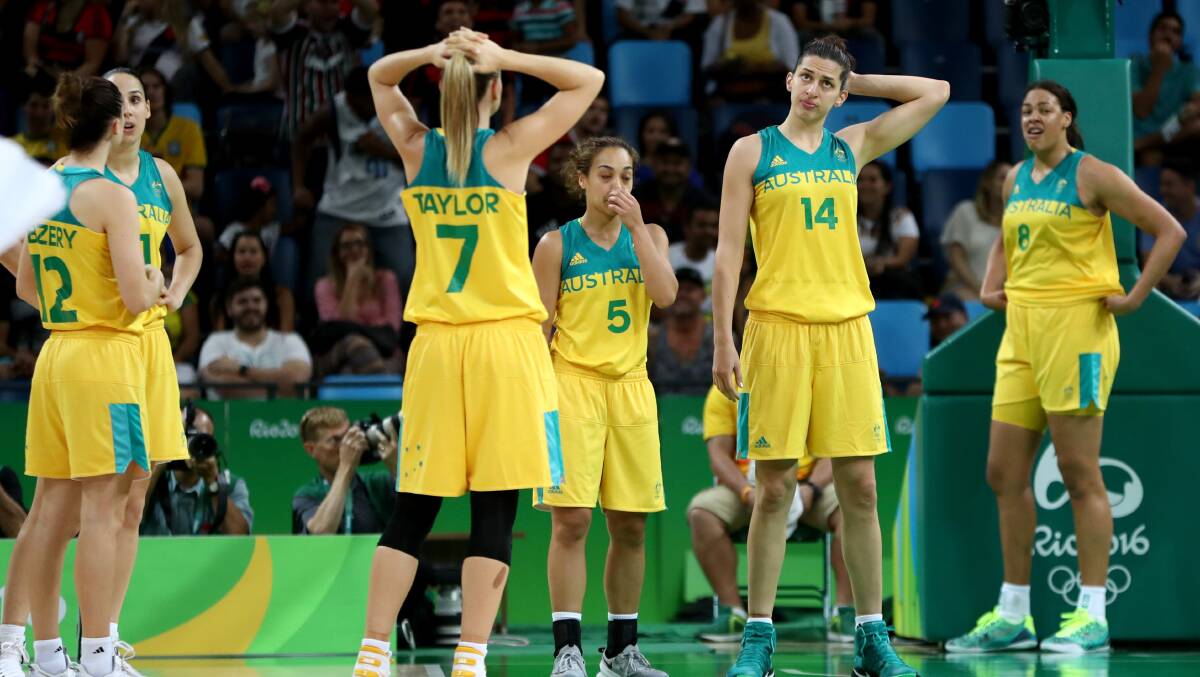 Australia stand dejected after their quarter-final loss. Photo: Phil Walter/Getty Images
