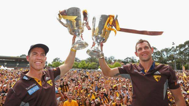 Coach Alastair Clarkson and captain Luke Hodge hold up the 2013 and 2014 premiership cups during the Hawthorn celebrations at Glenferrie Oval. Photo: Getty Images