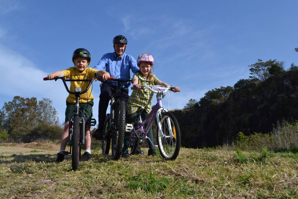 Luke Thompson, 8, Michael Thompson, and Lucy Thompson, 6, at the abandoned quarry, among residents pushing for a bike skills park there. Picture: Rebecca Fist