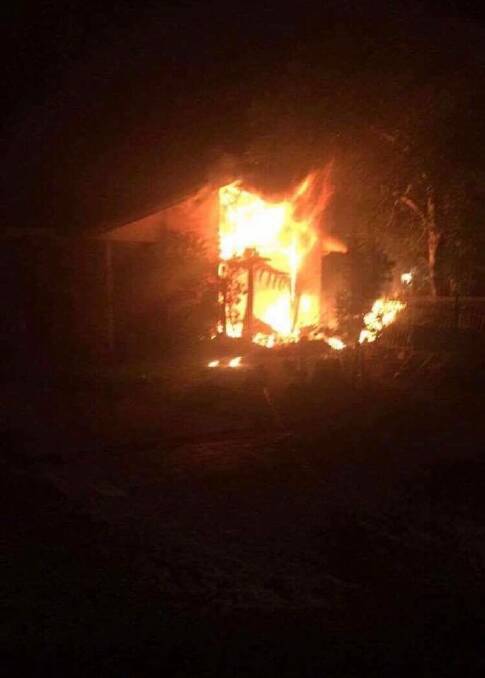 BLAZE: The home at Kingsford Smith Crescent, Sanctuary Point well alight on Friday night. Photo: St Georges Basin Rural Fire Service.
