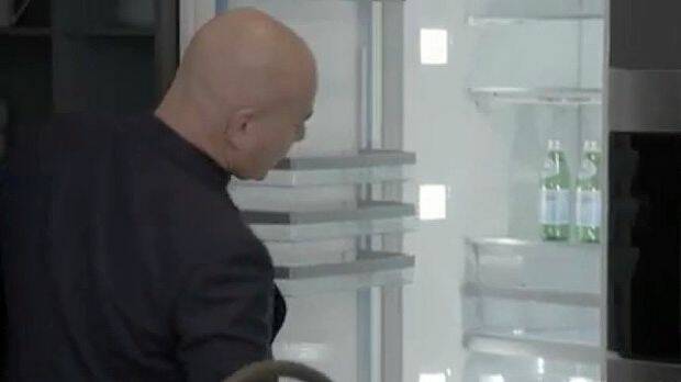 Neale inspects the size of Hannah and Clint’s fridge.
 Photo: Channel Nine/The Block