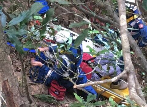 NSW Ambulance paramedics and other emergency services prepare to haul the injured man up the steep slope.