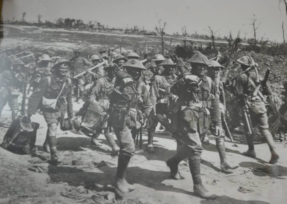 Sergeant Horace Brown (front) carries a machine gun out of Pozières with the 2/19 Machine Gun Battalion.