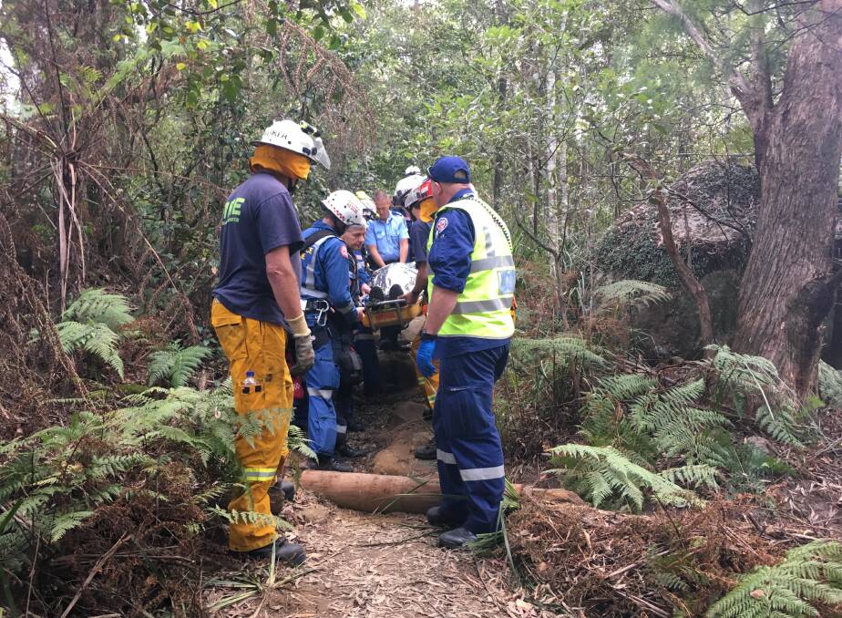 The 74-year-old injured man is carried out of the Drawing Room Rocks trail.
