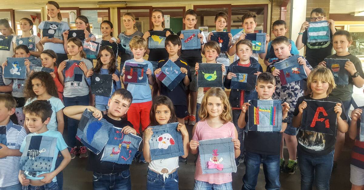 Kangaroo Valley Public School students proudly show off their denim creations to be used in a quilt for the Valley Children’s Medical Research Institute fundraiser.