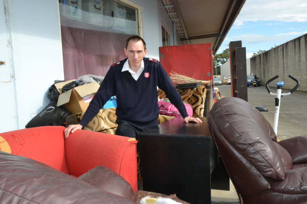 USELESS: Nowra Salvation Army Lieutenant Matthew Sutcliffe with some of the rubbish left dumped at the organisation's South Nowra store over the weekend.
