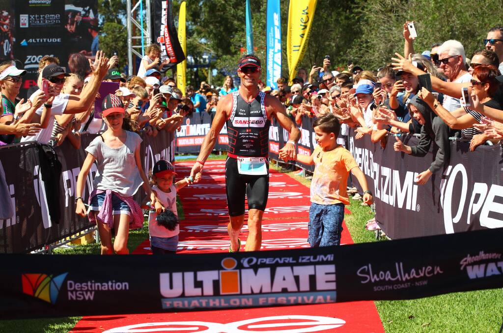 THE MAN:  Craig ‘Crowie’ Alexander crosses the line for his fourth Huskisson Lng Course win with his children, Lucy, Lani and Austin at the weekend. Photo: James Rankin