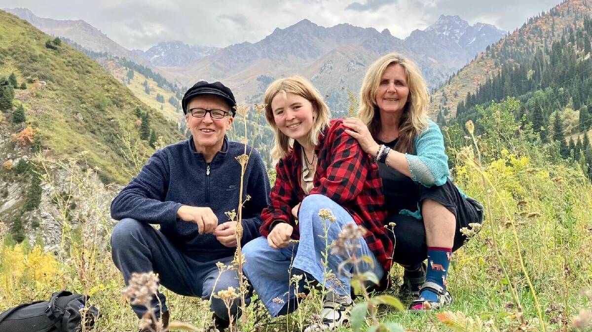 Environmentally conscious travellers Theo Simon and wife Shannon Coggins and their daughter Rosa, posing for a photo in front of mountains of Kazakhstan. Picture supplied