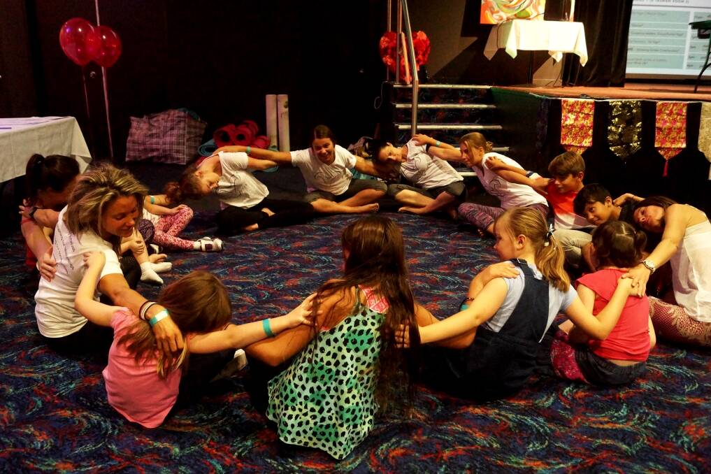 CHILLAXING: Zoe Braithwaite teaching children yoga at a previous Embrace Life Festival. Picture: Supplied