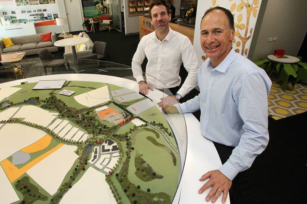 A model of the Calderwood Valley development with Brett Summers and Arthur Ilias from Lendlease in 2015. Picture: Greg Totman