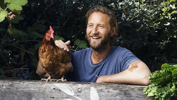 GARDEN TIME: Justin Hemmes in his garden in Vaucluse with a chook. Photo James Brickwood