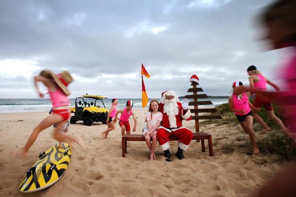 SANDY SANTA: Olivia Douglas poses for a picture with Santa at Jones Beach. Picture: Sylvia Liber