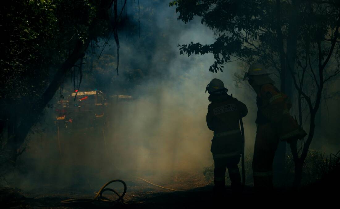 HAZE: Firefighters are shrouded in smoke during a controlled burn at Mount Kembla in November. Picture: Adam McLean