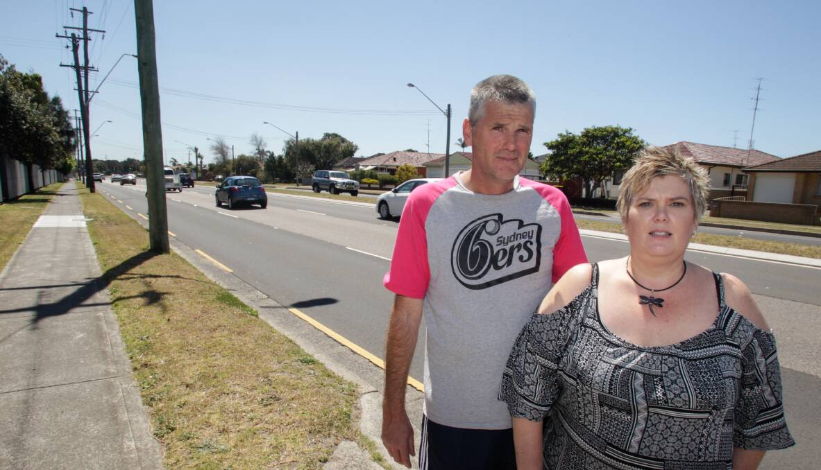 Windang Road residents Dean Bendall and Alison Louth are accustomed to hearing collisions on the busy stretch of road. Picture: Georgia Matts