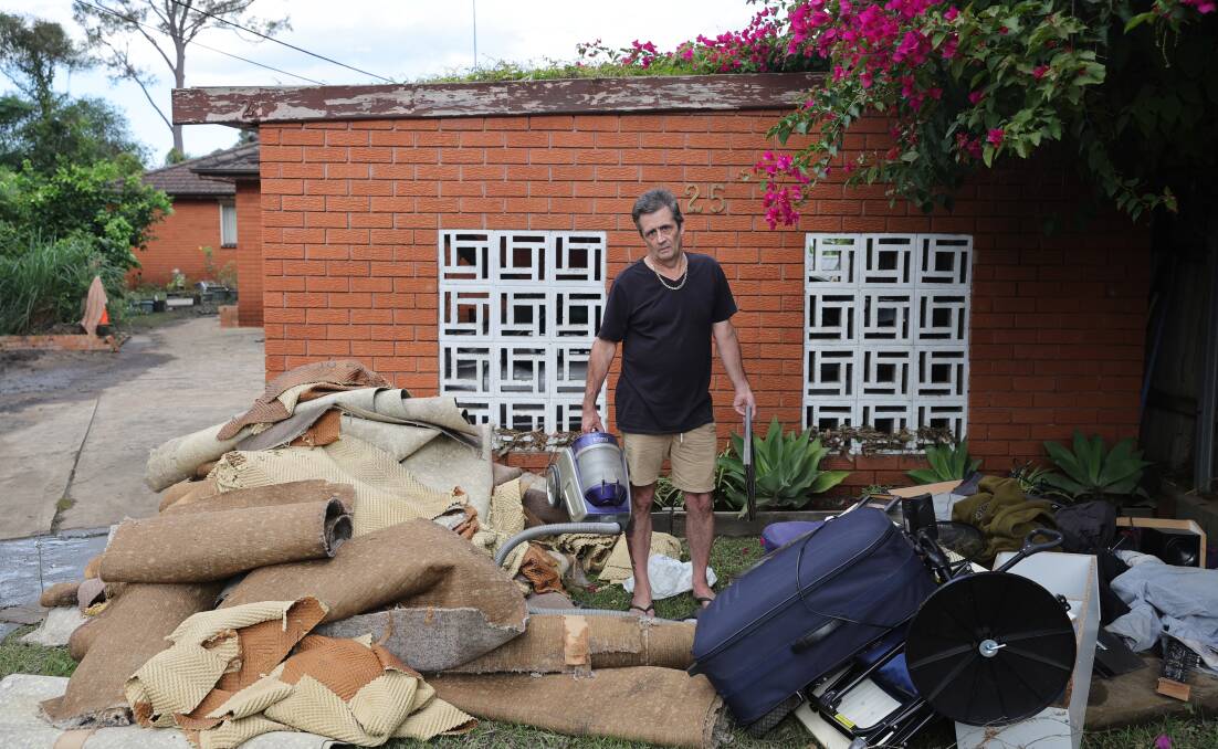 Bellambi's Brett Marraige with flood damaged household items. Picture April 7 by Sylcia Liber.