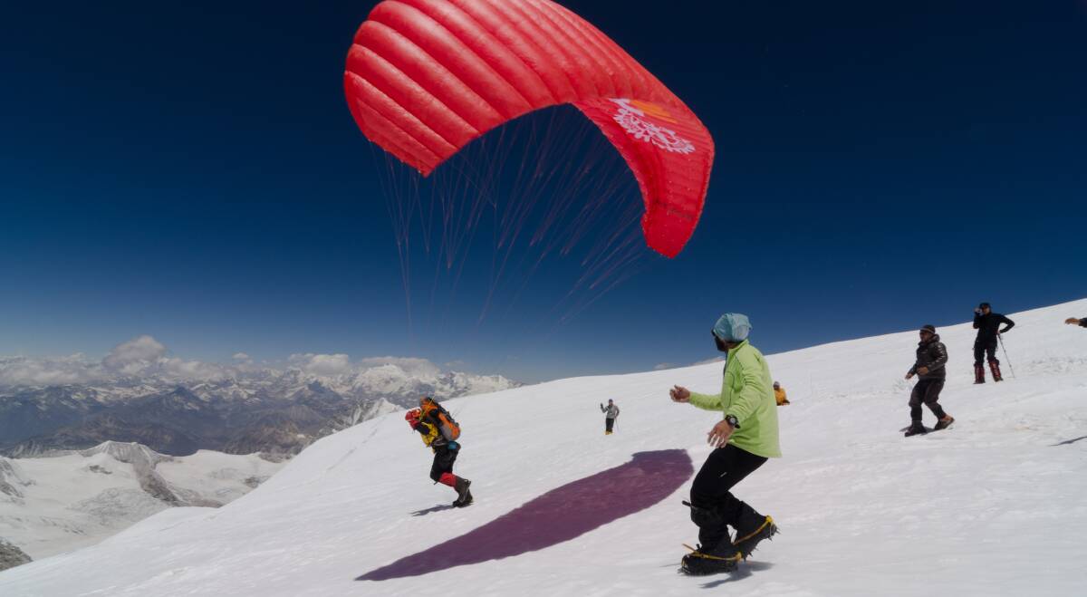 Mountain challenge: Ken Hutt, from the Rotary Club of Berry, launches his paraglider from the summit of the world's sixth highest mountain, to help promote Rotary's bid to eradicate polio worldwide.
