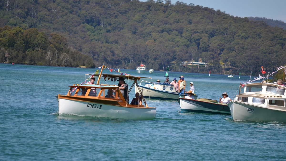 The sun came out and wind calmed just in time for the flotilla of traditional boats sail under the Narooma Bridge and along the boardwalk, lined by big crowds.