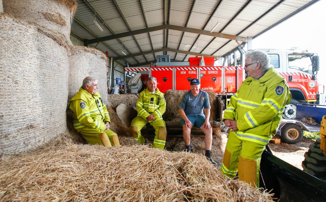COMMUNITY: Albion Park RFS members Fred Brown, Richard Johnston and Allan Gould with farmer Craig Tate who let the RFS operate from his hay shed for seven months while a new fire station was being built. Picture: Adam McLean
