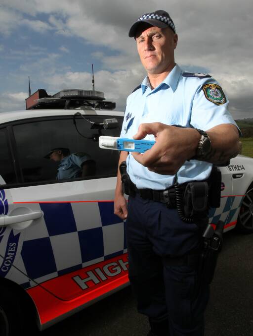 OUT IN FORCE: Sergeant Nicholas Park of the Lake Illawarra Highway Patrol with a Random Drug Testing device at the ready. Picture: GREG TOTMAN