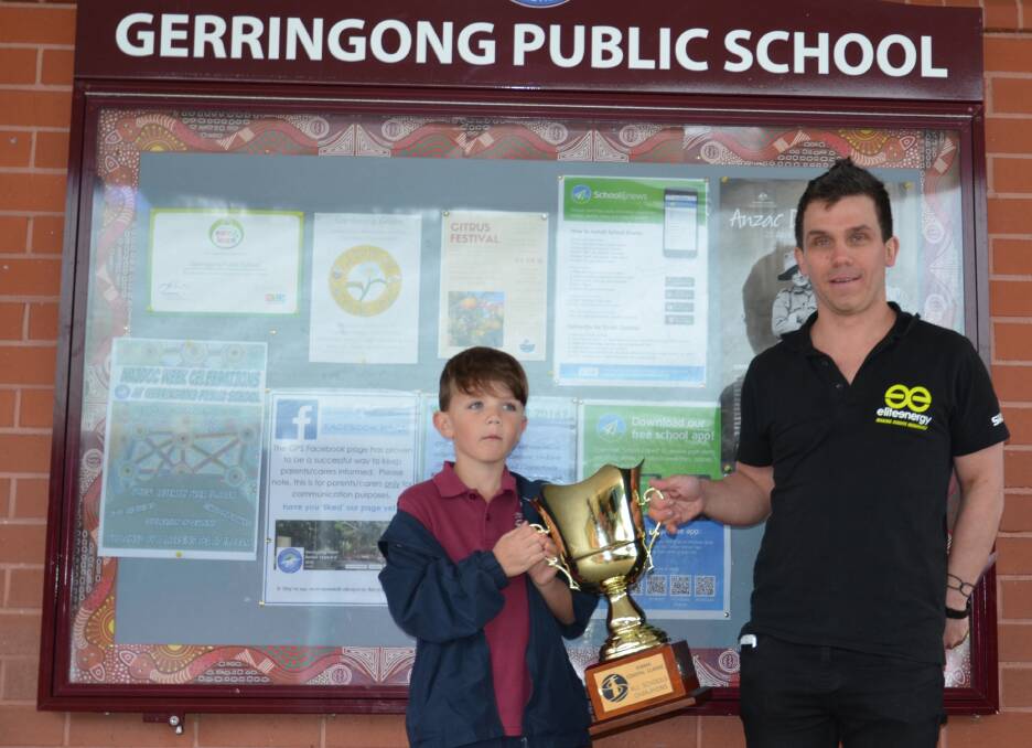 The Kiama Coastal Classic All Schools Trophy was presented  to Tynan Caswell by Sebastian Gallery of Elite Energy Events at a recent school assembly. Picture: Supplied