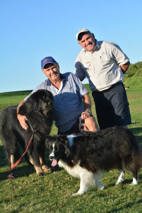 Canine Capers founder Ian Hornsby and Kiama council ranger Tom Ward, pictured with Archie and Angel.