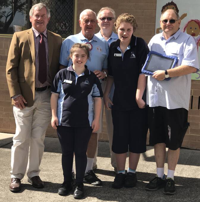 DONATION: Kiama Game Fishing Club president Mark Way, Minnamurra Lions Club president Ross Thompson and board member Brian Divers with David Kirkwood and students Laura Kirkwood (vice-captain) and Tali (captain). Picture: Brendan Crabb 