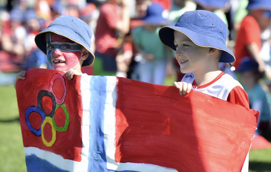 Arlen King (left) and Max Laird with the Norwegian flag. A total of 480 children from the school representing 18 countries participated.