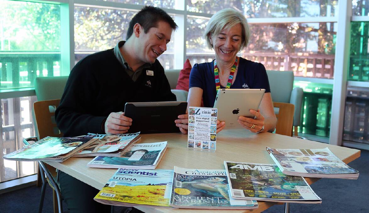 NEW TECHNOLOGY: Kiama Library staff members Michael Dalitz and Elizabeth Skorulis enjoying Zinio. Picture: Supplied