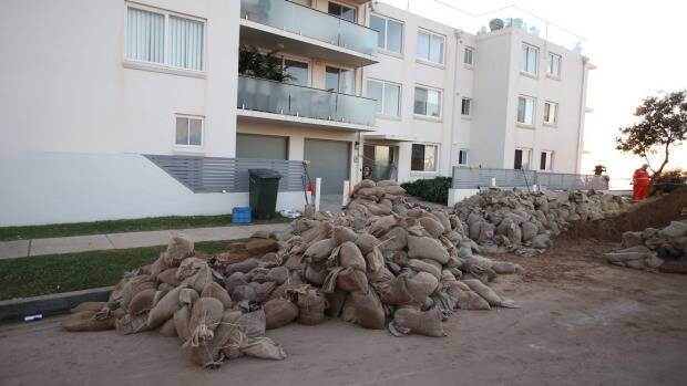 Sand bags surround Collaroy properties on Wednesday morning following another king tide that hit on Tuesday night. Photo: Peter Rae