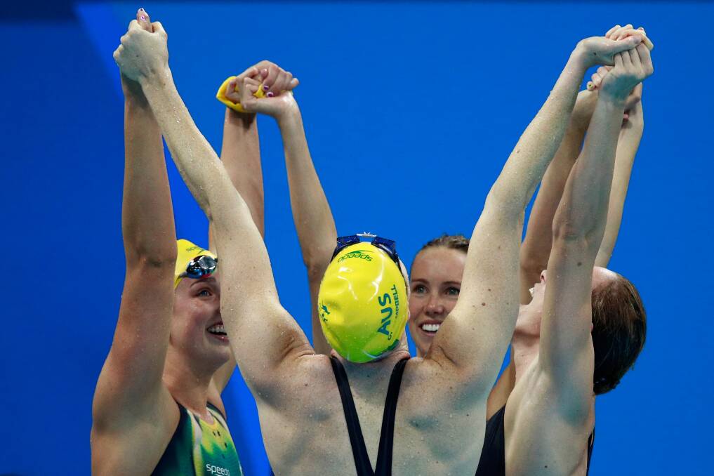 Australia’s women’s 4x100m freestyle relay team celebrate their world record and gold medal.  
