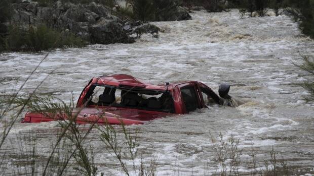 A Canberra man was killed on June 5 after his four-wheel drive was swept upstream in a swollen riven during wild weather. Photo: Graham Tidy