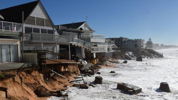 High tide sweeps against beachfront homes along Pittwater Road at Collaroy after the monster east coast low. Photo: AAP