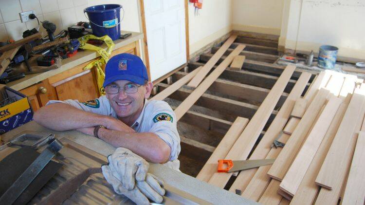 Peter Rigozzi, working on the floor of one of the lighthouse buildings. Photo: Tasmania Parks and Wildlife Service

