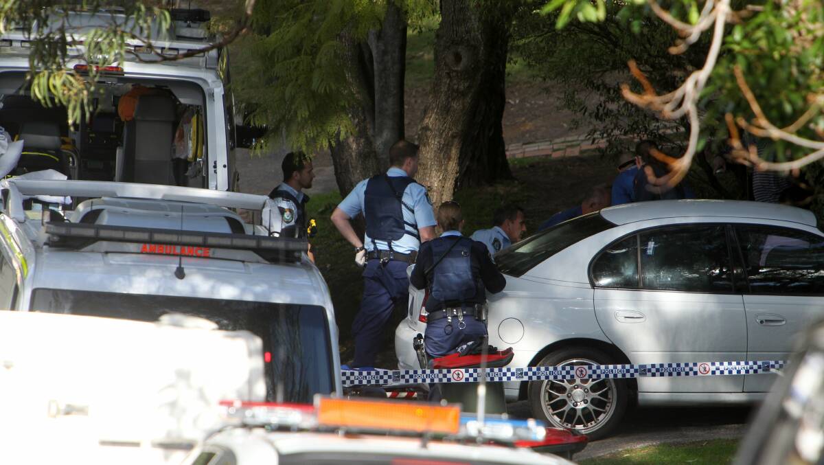 Police outside the crime scene in a Wollongong front yard. 