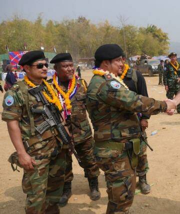 Mr Simpkins greets Karen guerrillas at their Revolution Day event in Myanmar. Photo: Steve Sandford