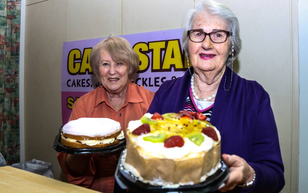 The Friends of Blue Haven helper June Griffin and president of The Friends of Blue Haven Aged Care Facility Mary Douglas prepare for the annual cake stall. Picture: GEORGIA MATTS