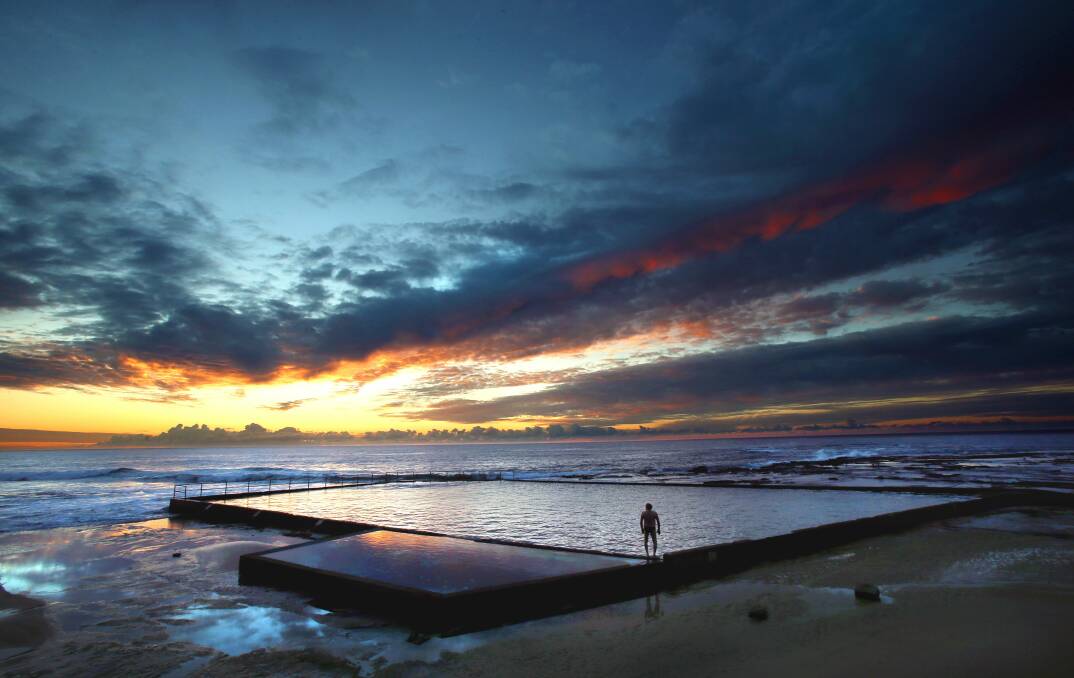 Dawn breaks over Woonona rock pool in this scenic Illawarra Mercury photo. Picture: KIRK GILMOUR