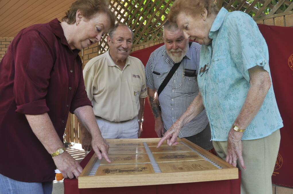 Shellharbour Woodcarvers members Frank O'Connor (second from left) and Ted Furlong, flanked by Shellharbour Hospital Auxiliary members Edna Harley (left) and Denise Pawson, donate the eight-piece pyrography mosaic. Picture: ELIZA WINKLER